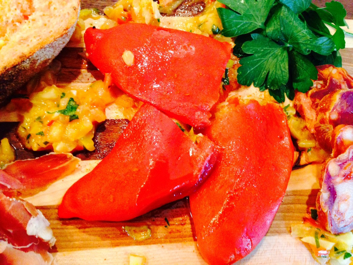 White bean and fennel sofrito stuffed piquillo peppers with Spanish tomato and garlic bread, Serrano ham, and dried hot Chorizo