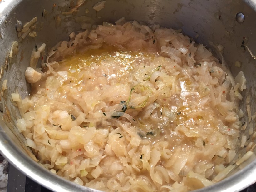 The soup pot with the onions about half way reduced by volume.  