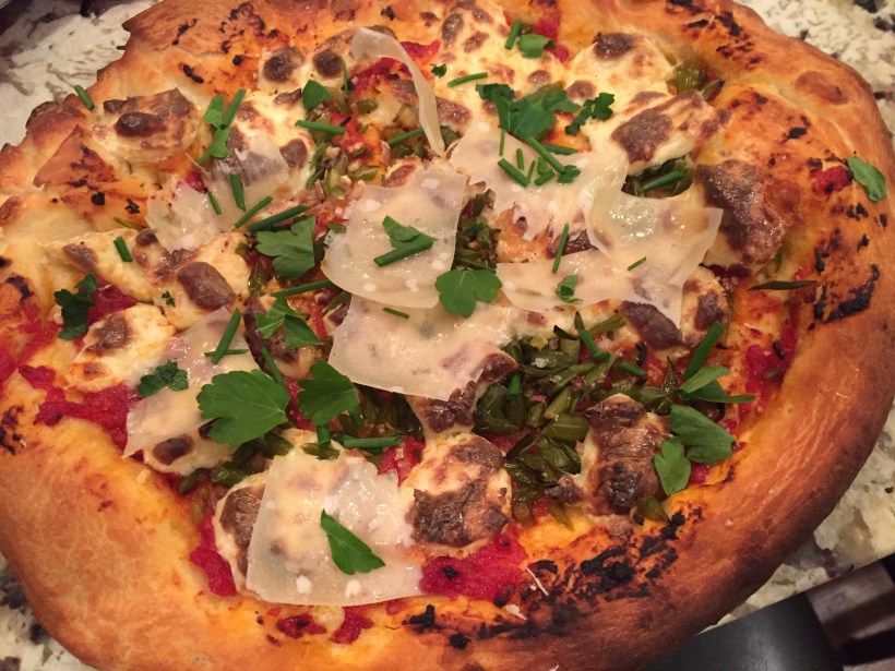 Garlic scape pizza with shallot, tomato sauce and homemade mozzarella 