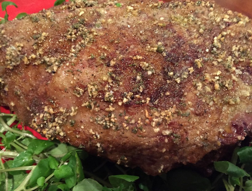 A closer look at the browned outer crust of herbs and garlic.