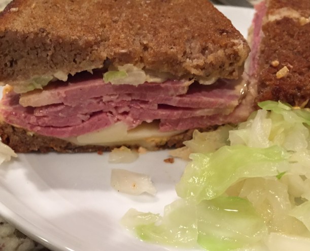 Classic Corned Beef Reuben with seeded rye bread, Thousand Island dressing, sauerkraut, and gruyere cheese.