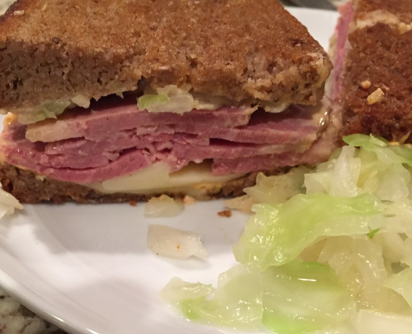Classic Corned Beef Reuben with seeded rye bread, Thousand Island dressing, sauerkraut, and gruyere cheese.