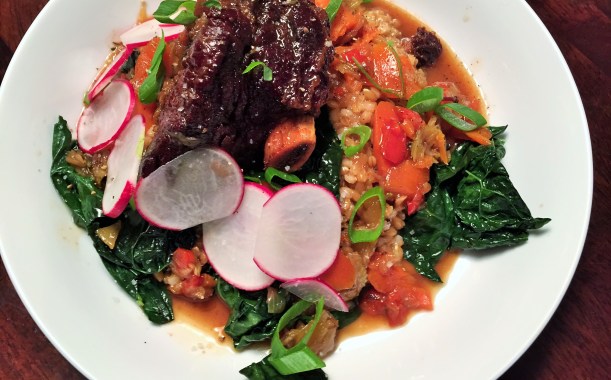 Lavender, honey, and sherry short ribs with risotto style farro and wilted greens.
