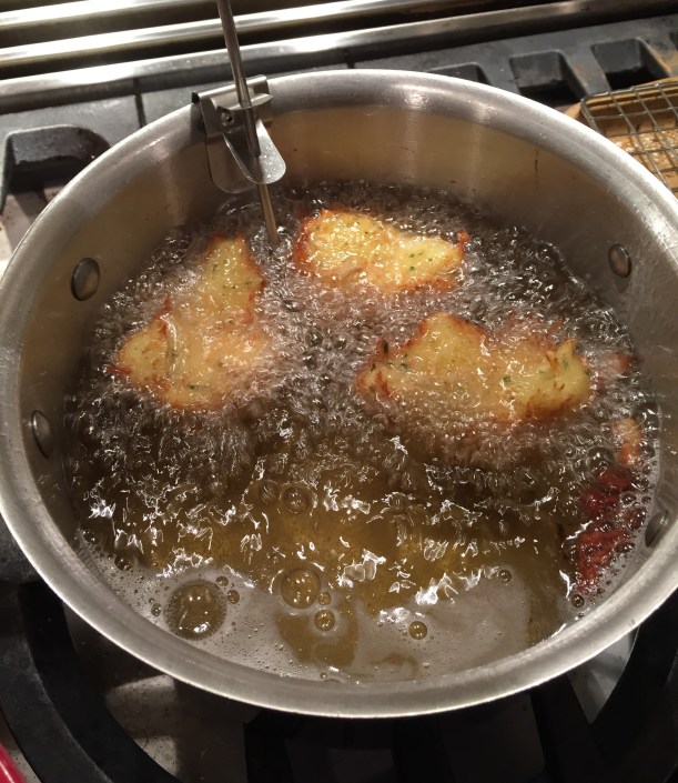 Fritters are fried at 350 degrees in safflower oil.  Use a thermometer to monitor the temperature of the oil.