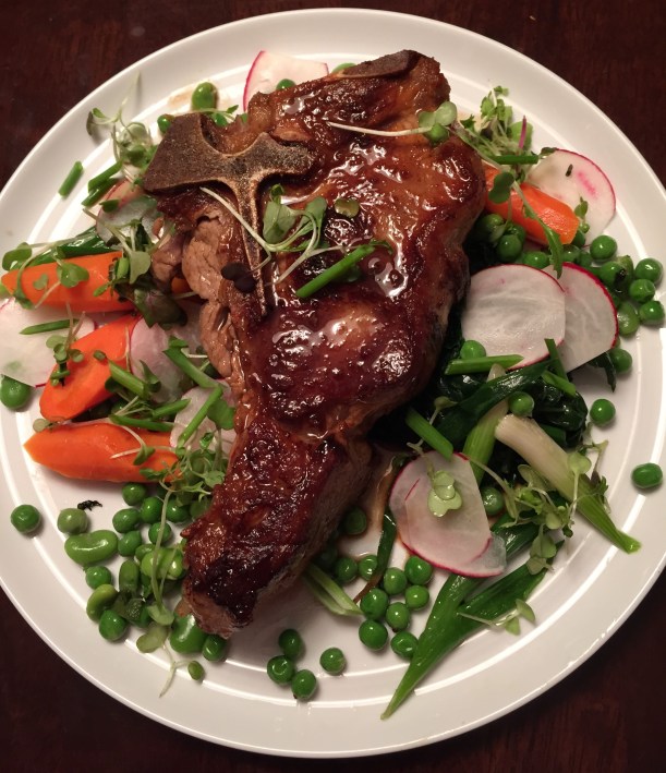 Veal chop, glazed with a veal stock and white wine reduction, served with a variety of simply prepared spring vegetables.